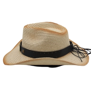Detail of woven straw cowboy hat featuring vintage scorched edges and star metal studs