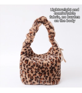 Detail of leopard print faux fur crossbody bag with ruffled handle and ribbon bow