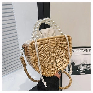 Detail of handmade woven bamboo bag with white pearl handle and drawstring lining