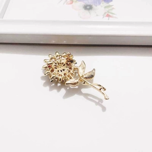 Detail of sunflower brooch back showing gold plating and secure safety pin fastener