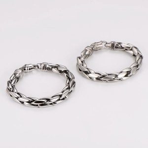 Macro view of polished and matte braided stainless steel chains with lobster clasps