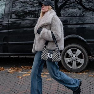 Elegant grey faux fur coat with collar styled with denim jeans for a chic winter look