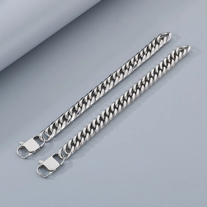Close-up of dual-link silver Cuban chain bracelet with sturdy lobster clasp detail