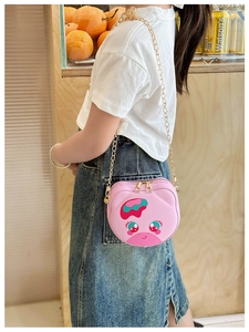 Girl wearing a pink cartoon crossbody bag with golden chain and cute round animal design