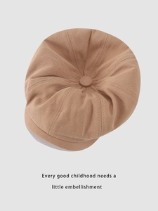 Top view of a camel cotton newsboy cap for kids with eight-panel stitching and a button