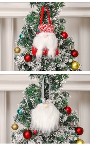 Detail of plush Christmas gnome ornaments hanging on a tree with soft white beard