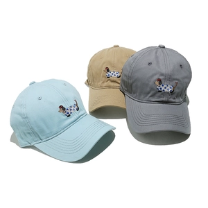 Detailed close-up of three cotton baseball caps with cute sausage dog embroidery