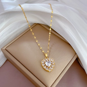 Macro detail of a gold-tone heart pendant with sparkling pavé micro-inlaid cubic zirconia