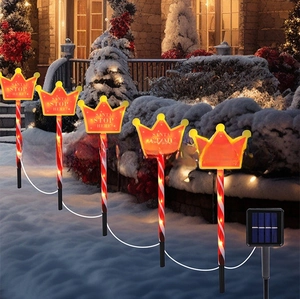 Solar Christmas candy cane garden lights with Santa Stop Here sign in snow