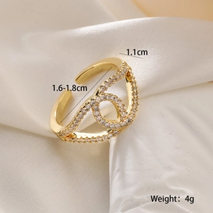 Detailed view of hollow heart geometric ring with white zircon pave and golden finish