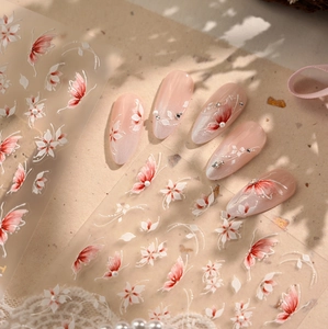 Macro detail of 3D pink and white butterfly floral nail stickers with pearl accents