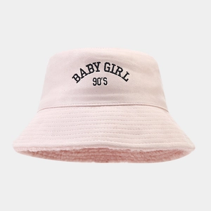 Detailed close-up of pink bucket hat with BABY GIRL 90'S embroidery and warm fleece lining