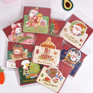 Group of festive mini Christmas greeting cards with cartoon illustrations and envelopes