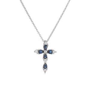 Macro view of cross pendant necklace featuring pear-cut blue crystals in silver setting