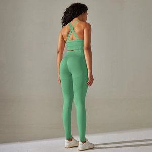 Detail view of mint green seamless yoga set with cross-back sports bra and high-waist leggings