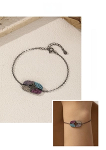 Detail of S925 silver star bracelet featuring colorful zircon stones and dark metal chain