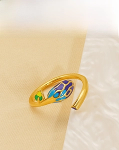 Macro shot of 18k gold plated stainless steel ring with colorful enamel inlay detail