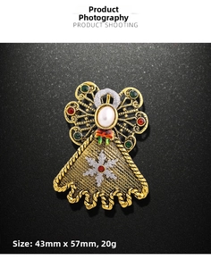 Detailed view of an angel brooch with rhinestones and white pearl measuring 43mm by 57mm