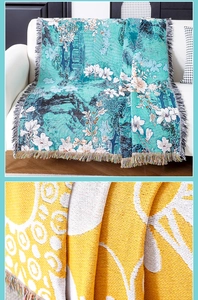 Close-up of woven floral tapestry throw blanket with decorative colorful fringe texture