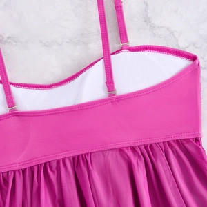Close-up of hot pink tankini with adjustable metal straps and pleated mesh skirt detail