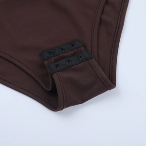 Detailed close-up of snap-button closure on dark brown knit bodysuit for women