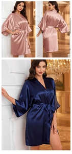 Detail of silk satin robes in rose gold and navy blue with elegant waist tie and V-neck