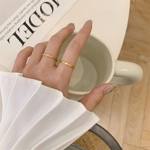 Set of two textured 18K gold plated stackable rings with solar pattern for women