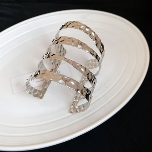 Detailed view of silver layered cuff bracelet featuring a textured hammered metal finish
