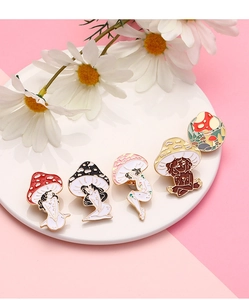Detailed set of five creative mushroom girl enamel pins on a white ceramic display plate