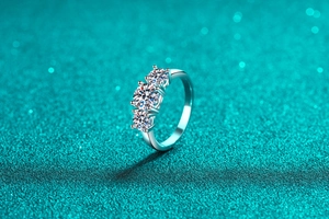 Macro shot of three-stone S925 sterling silver ring with sparkling round moissanite