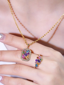 Detail of 18K gold plated necklace and ring set featuring colorful square gemstones
