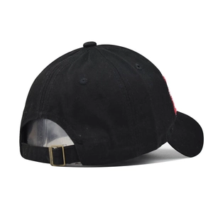 Detail of adjustable metal buckle and red embroidery on washed black cotton baseball cap