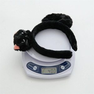 Close-up of black plush cat headband showing soft fuzzy material and cat head embroidery