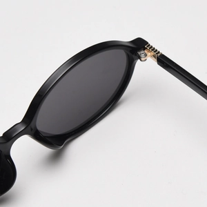 Close-up of the durable metal hinge and reinforced structure on small oval sunglasses