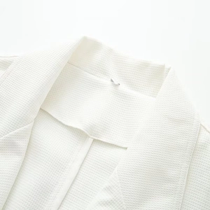 Minimalist white waffle texture coat for women featuring a sharp lapel and clean tailoring