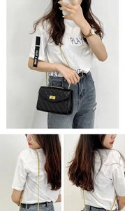 Detail of black quilted crossbody bag with gold chain strap and metallic square lock