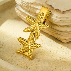 Elegant 18K gold plated starfish hair clip in stainless steel on a beige stone tray