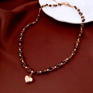 18k gold plated tiger eye heart pendant necklace with beads on silk background