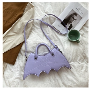 Detail of purple bat-shaped PU handbag with spiderweb patterns and cross decoration