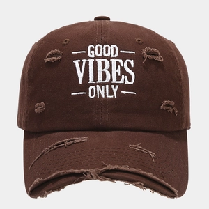 Detail of Good Vibes Only white embroidery on vintage distressed dark brown baseball cap