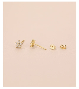 Macro shot of S925 sterling silver star stud earrings with white zircon on pink leather