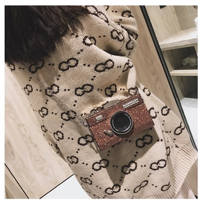 Detail of brown glitter camera bag with silver chain and Steal the Spotlight text