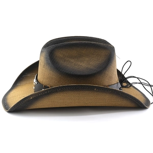 Detail of brown straw cowboy hat with black gradient edge and silver metal ornaments