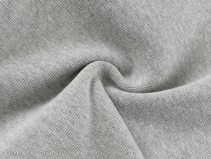 Detailed macro view of gray marl knit fabric texture on high-waist athletic shorts