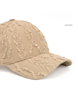 Close-up of khaki baseball cap featuring textured seersucker fabric and foldable brim