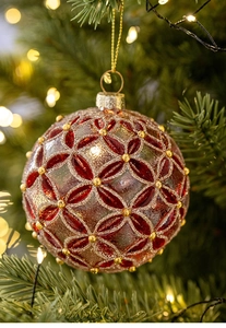 Detail of 8cm frosted Christmas glass ball with red leaf pattern and gold beads on tree