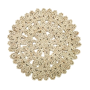 Handwoven round corn husk placemat with hollow floral pattern and scalloped edges