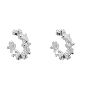 Detailed macro view of silver heart ear cuffs featuring sparkling cubic zirconia stones