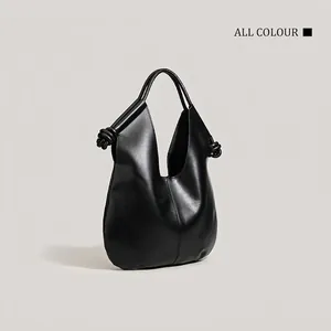 Minimalist black leather tote bag with elegant knot details for commute