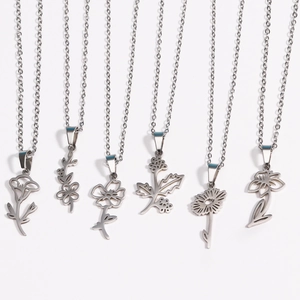 Flat lay detail of six silver stainless steel floral pendants with delicate O-chains
